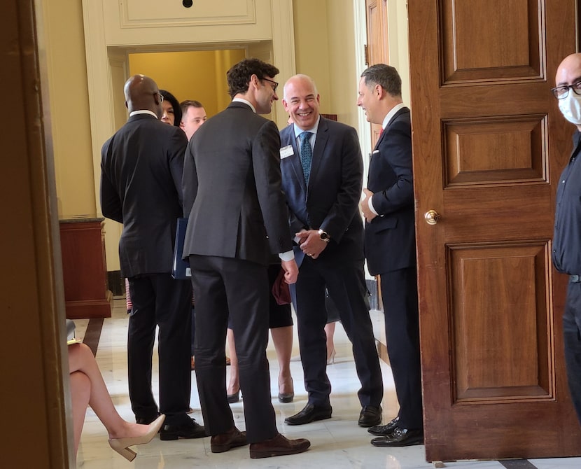 Sen. Rafael Warnock, D-Ga., speaks with state Reps. Chris Turner, D-Grand Prairie, and...