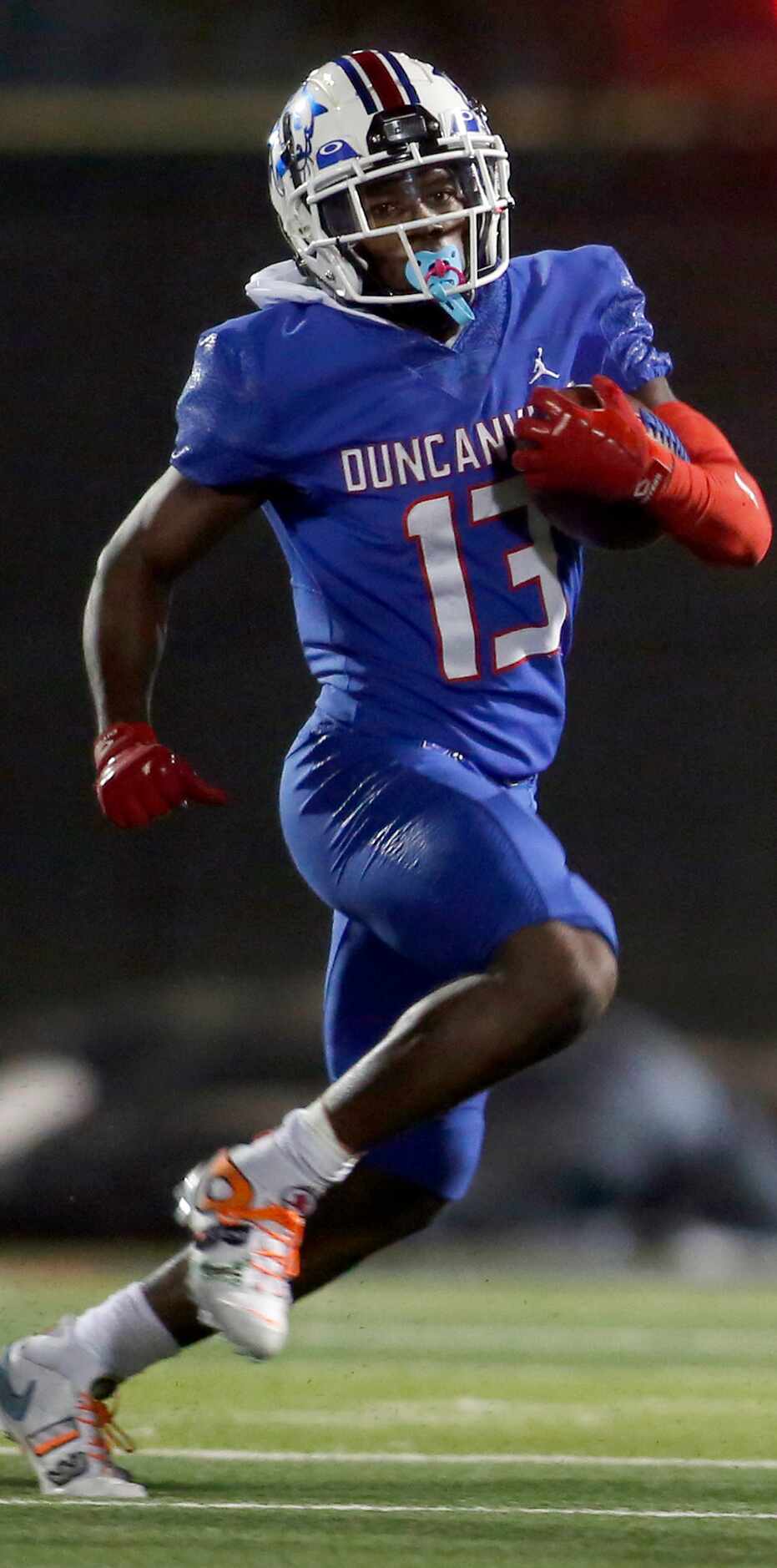Duncanville receiver Roderick Daniels (13) looks for running room as he rambles into the...