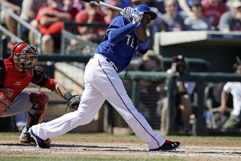 Texas Rangers' Jurickson Profar, right, watches a solo home run during the third inning of a...