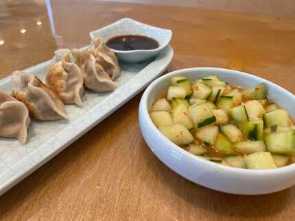 Pork and cabbage pan-fried dumplings and smashed pickled cucumbers at Hello Dumpling on...