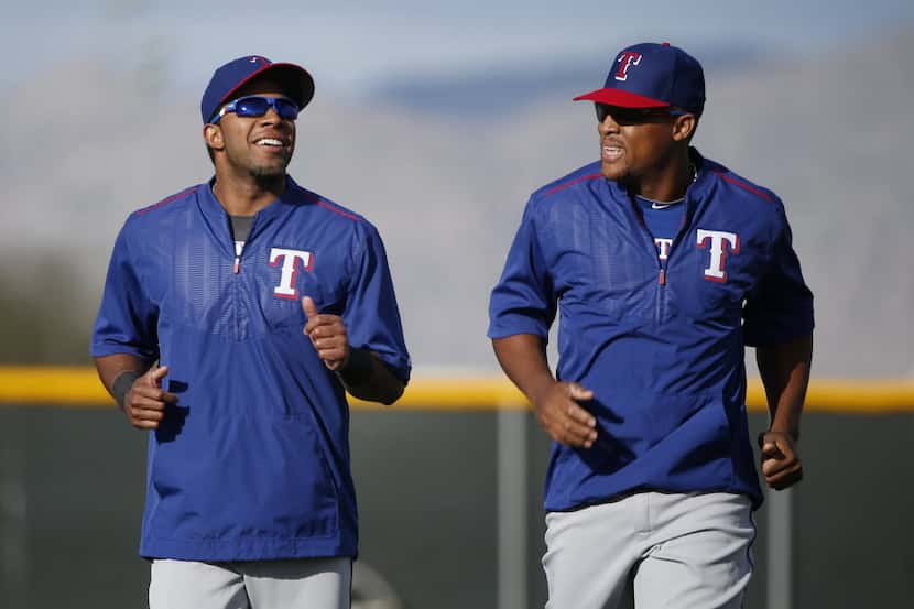Texas Rangers shortstop Elvis Andrus and third baseman Adrian Beltre speak to each other...