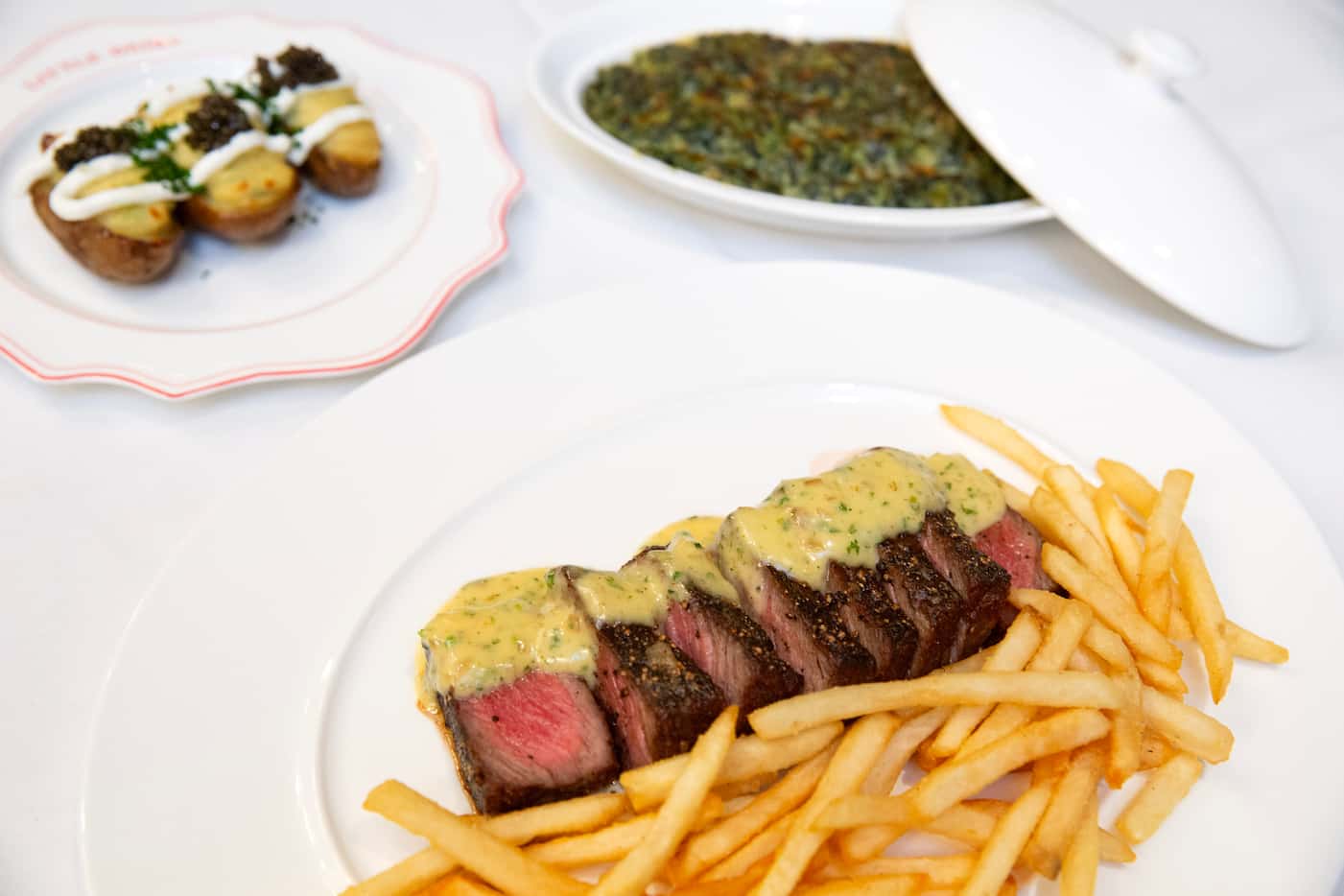 Little Daisy's steak frites, bottom right, can be ordered with sides like creamed spinach or...