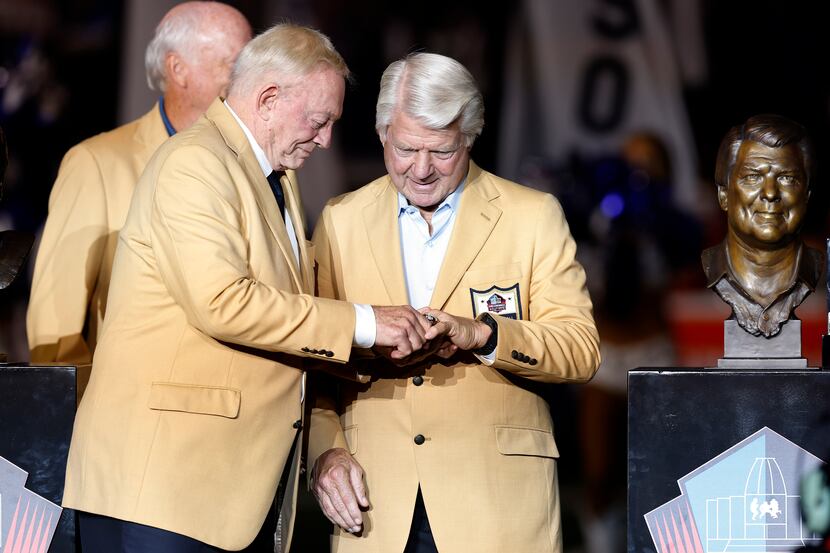Dallas Cowboys owner Jerry Jones pushes the  Pro Football Hall of Fame ring onto former...