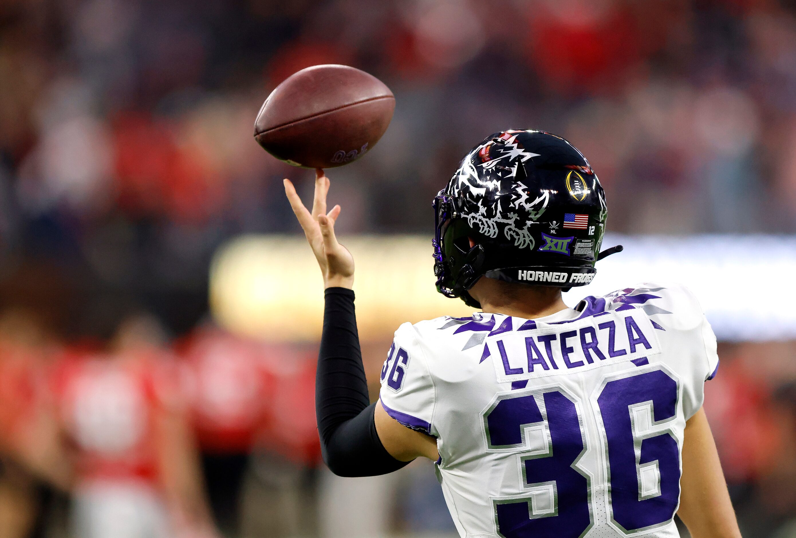 TCU Horned Frogs long snapper Joe Laterza (36) spins the football on his finger before...