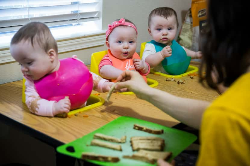 Actress Allison Pistorius (right) feeds her triplets (from left) Austen Finch Pistorius...