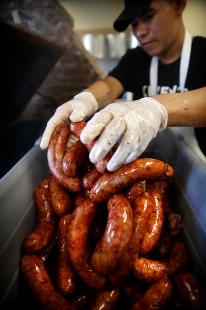 
Smoked sausages are pulled from the smoker at Killen’s in Pearland.
