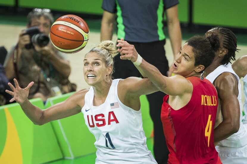 Elena Delle Donne (11) of United States grabs a rebound away from Laura Nicholls (4) of...