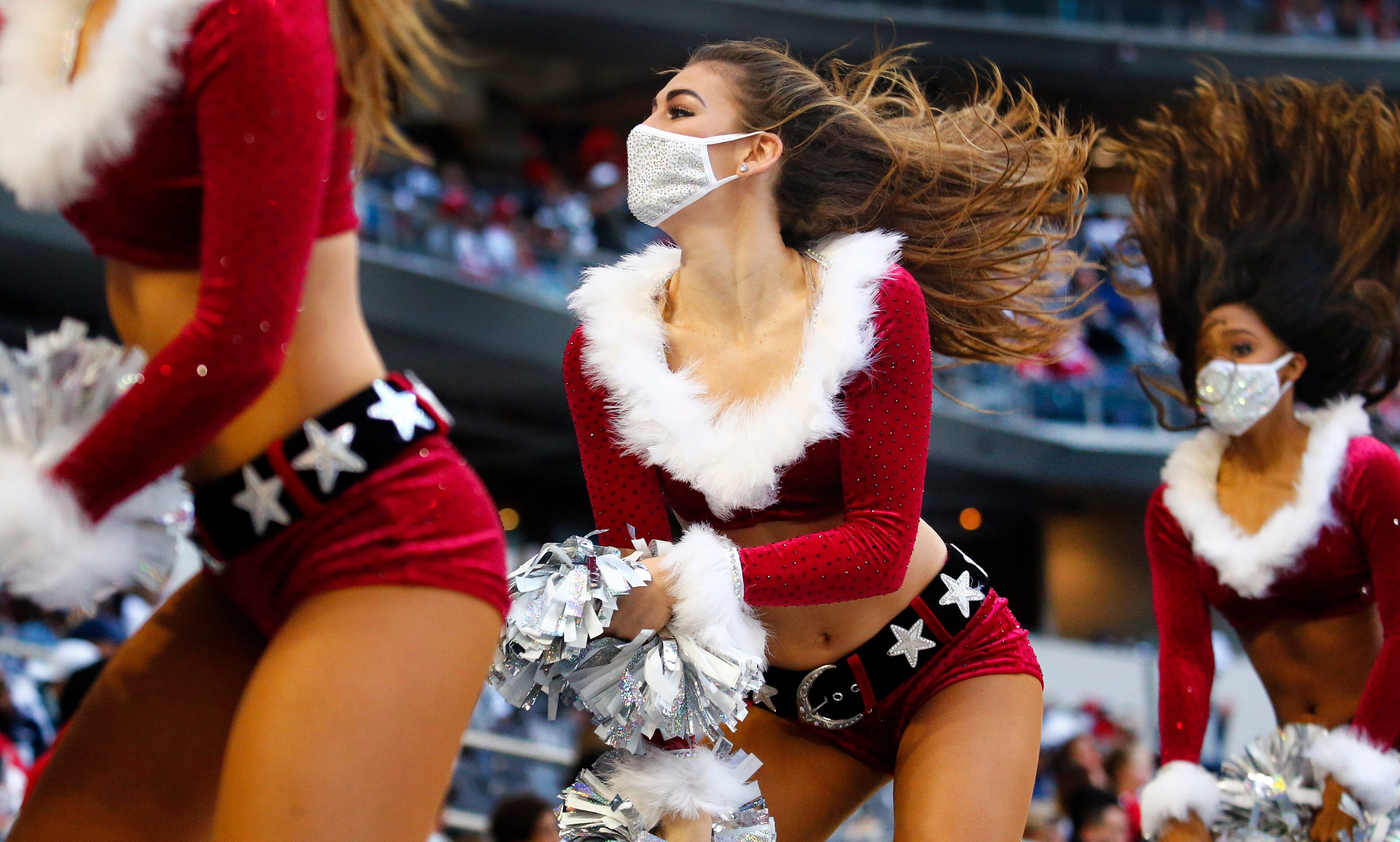 The Dallas Cowboys Cheerleaders perform inter Christmas holiday outfits during the San...