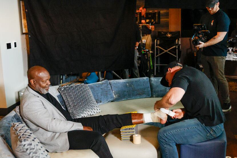 Former Dallas Cowboys running back Emmitt Smith has his ankle taped before filming a...