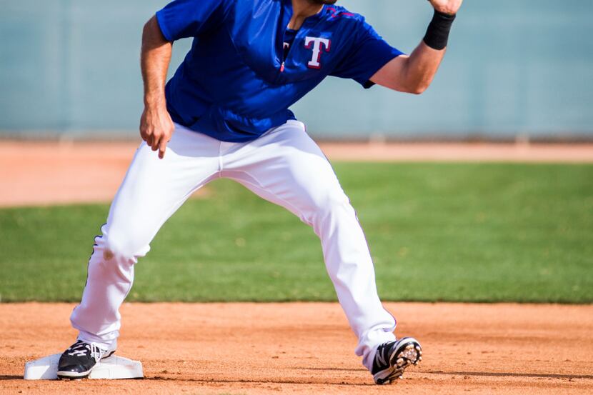 Texas Rangers designated hitter Joey Gallo (13) catches a throw to third base during a...