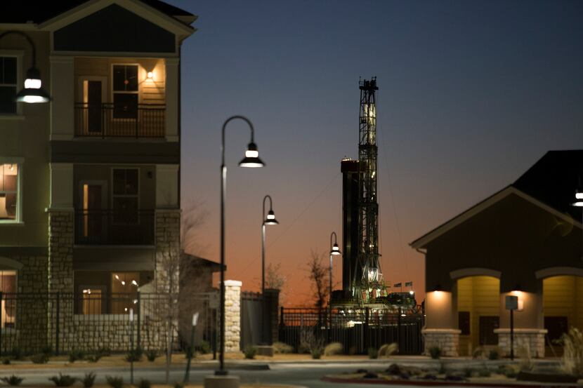 An new oil well is drilled near new apartments in Midland, Texas, Jan. 29, 2016. There are...