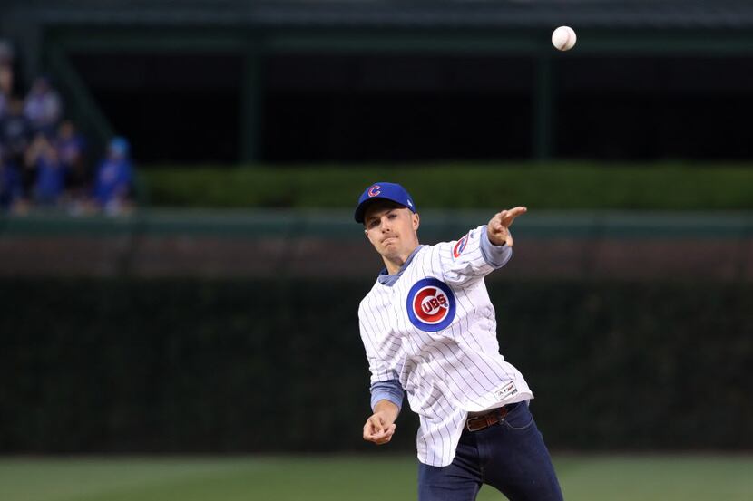Professional golfer Jordan Spieth throws out a ceremonial first pitch as the Chicago Cubs...