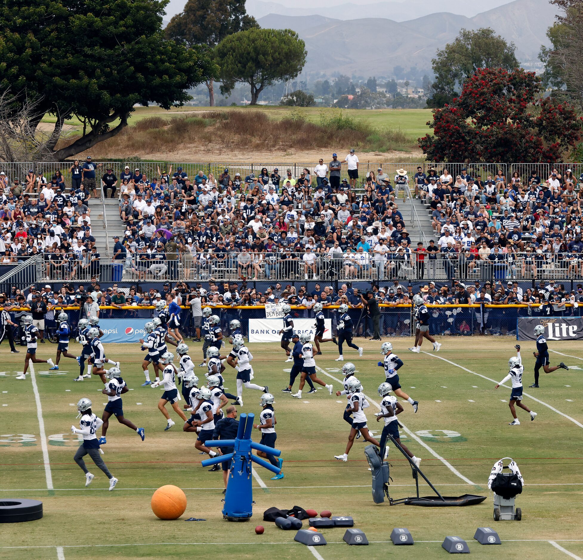 The Dallas Cowboys football team trains before over 4,000 fans at the Cowboys training camp...