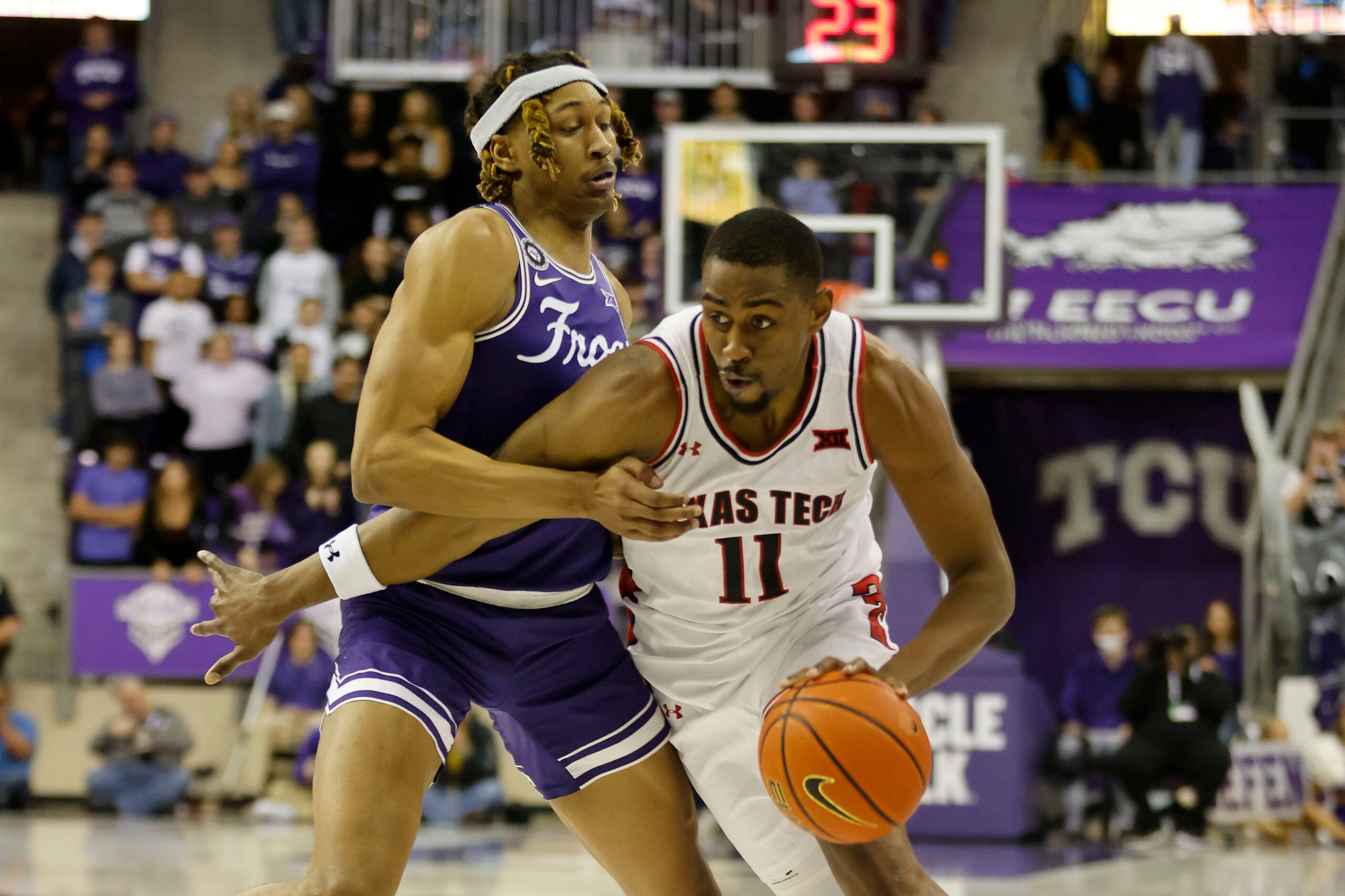 TCU forward Xavier Cork (12) defends against Texas Tech forward Bryson Williams (11) during...