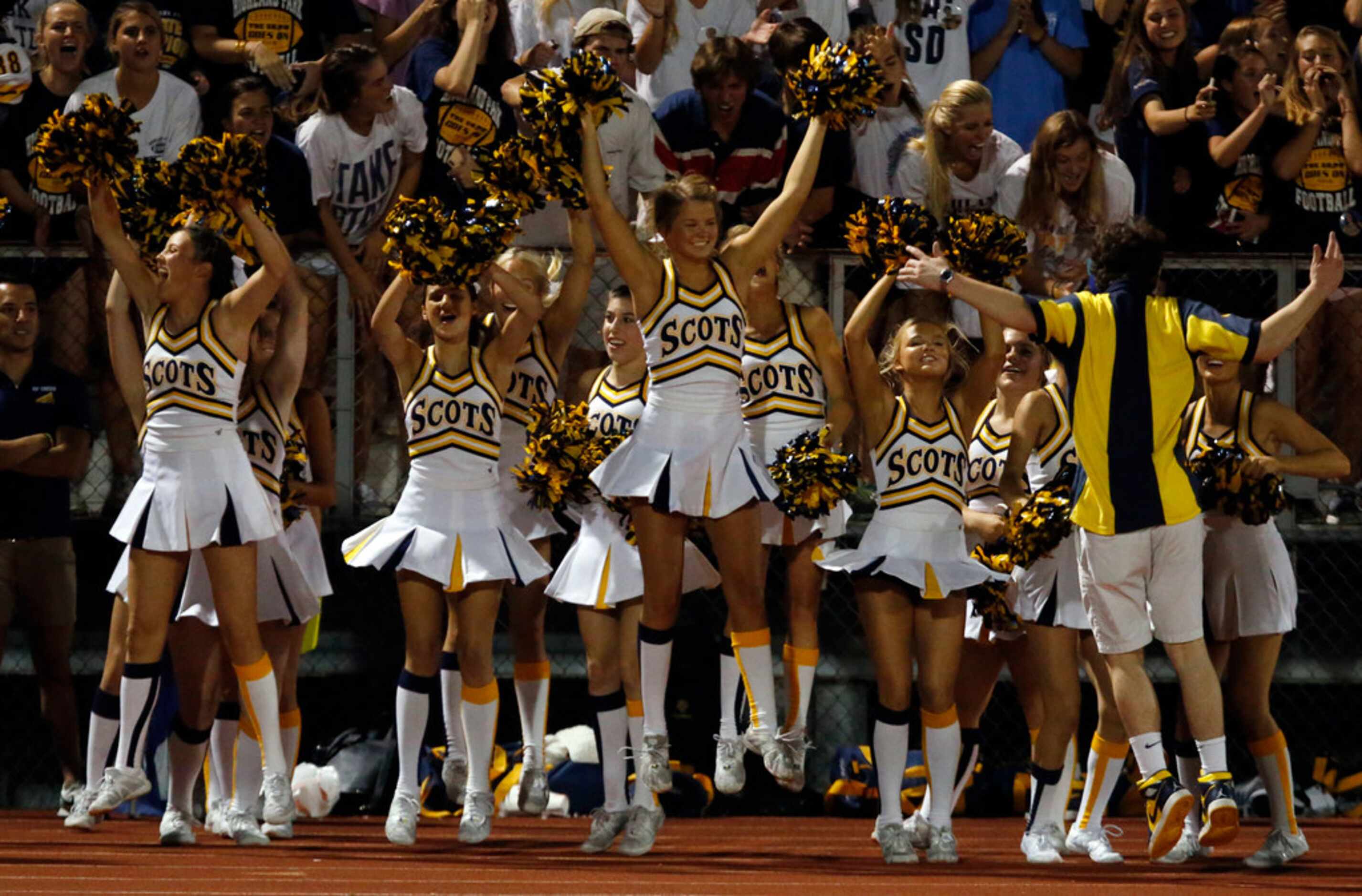 The Highland Park High cheerleaders jump for joy as the team scores and ties up the score...