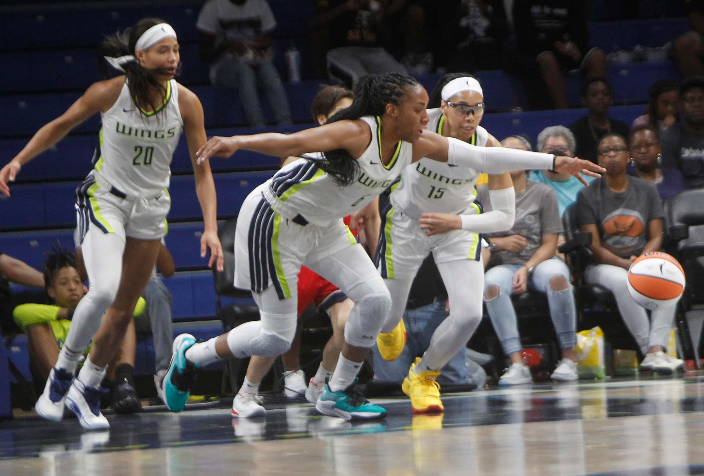 Dallas Wings forwards Isabelle Harrison (20), left, and Kayla Thornton (6), center are...