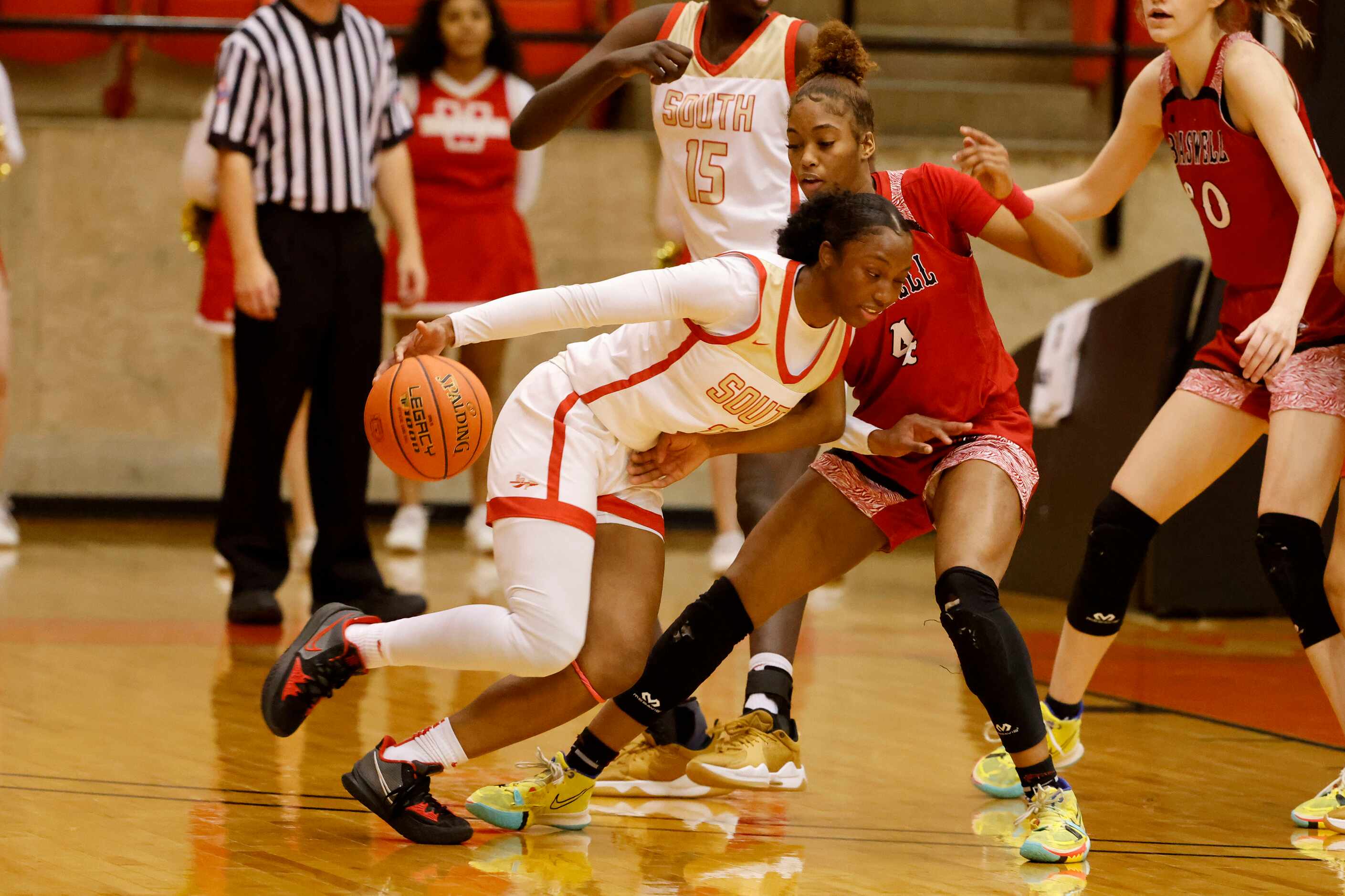 South Grand Prairie’s Jahcelyn Hartfield (11) tries to get past Denton Braswell ’s Kennedy...
