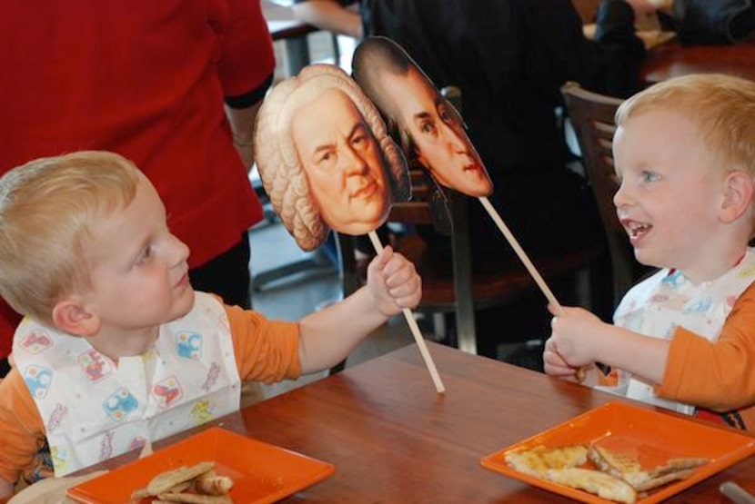 
Twins Jack and Justin Rollins play with their friends, Bach and Mozart.
