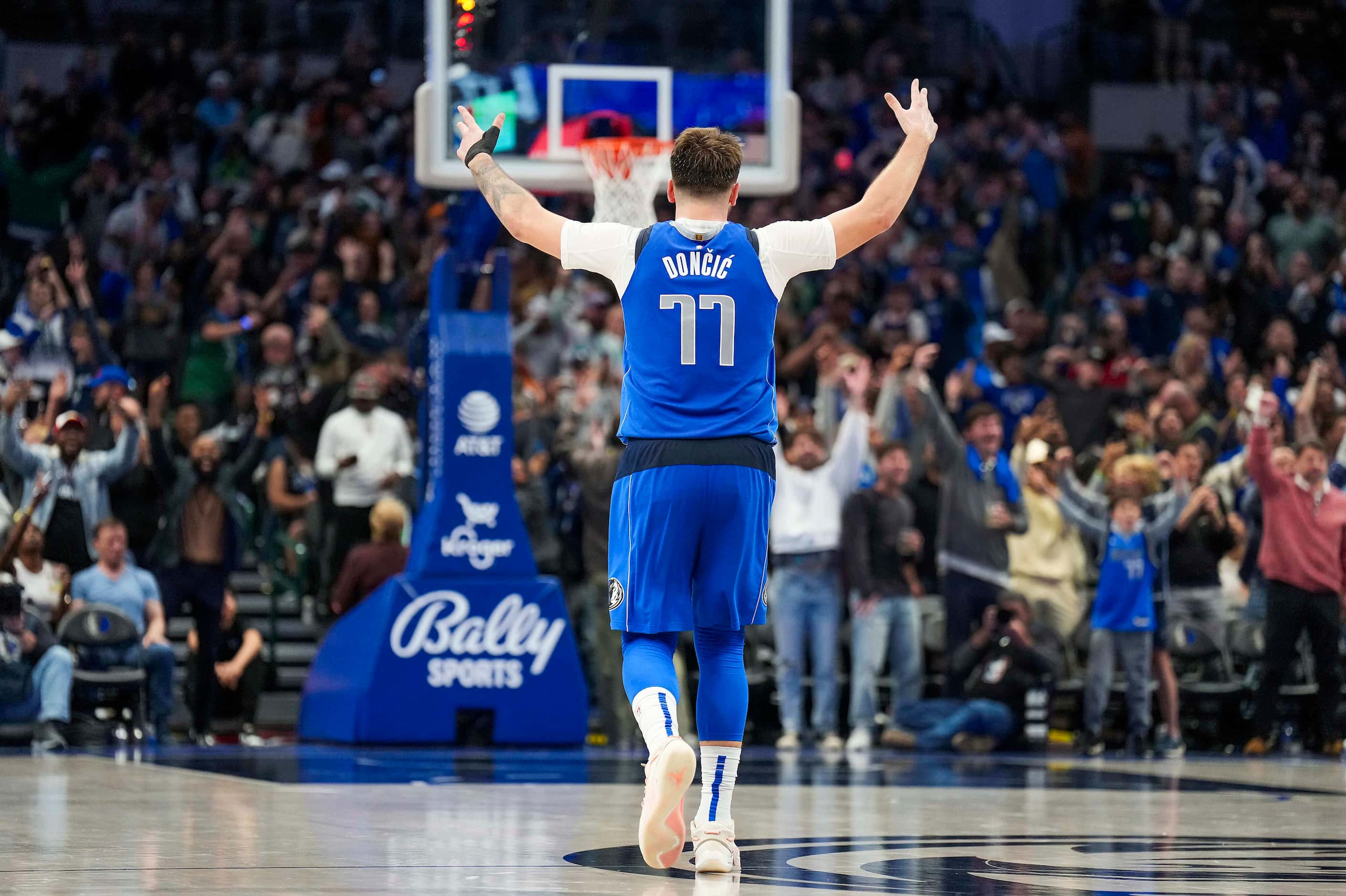 Dallas Mavericks guard Luka Doncic celebrates after his alley-oop to Dereck Lively II tied...