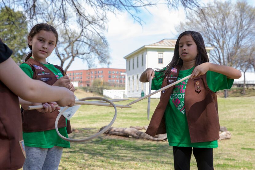 Frisco's Girl Scout Brownies Troop 8004 member Zara Khan (right) teaches fellow Brownies how...