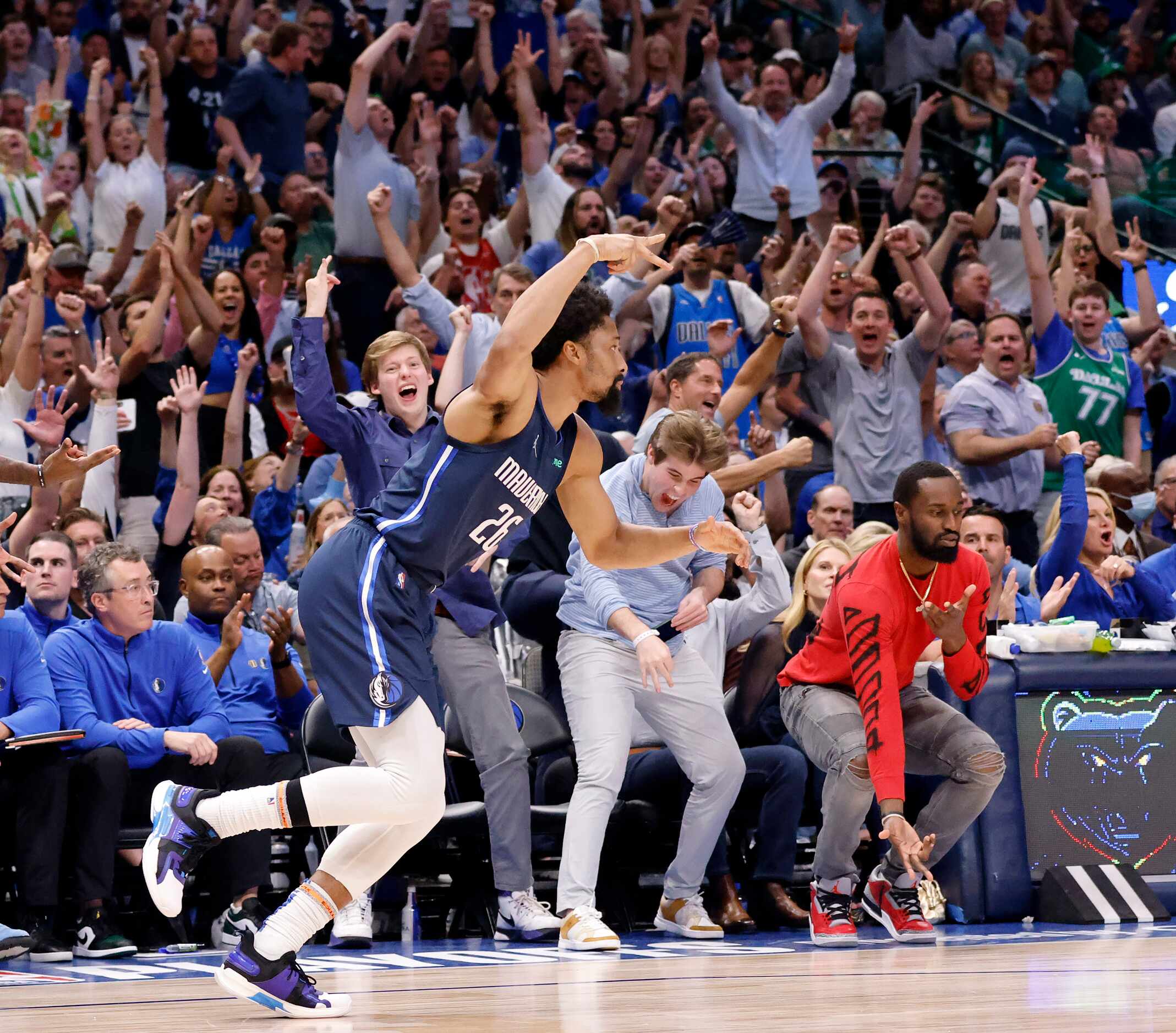 The fans celebrate along with Dallas Mavericks guard Spencer Dinwiddie (26) who hit a fourth...