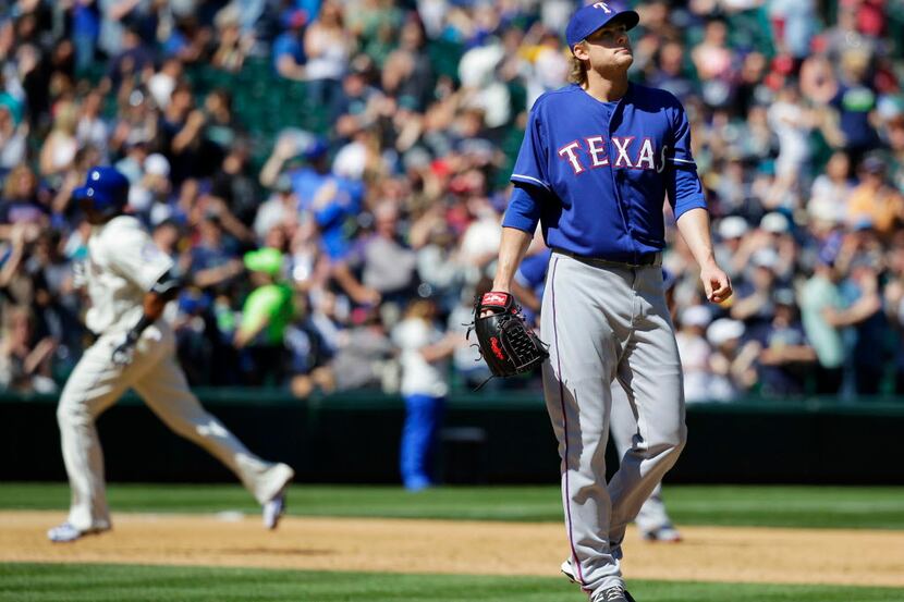 Texas Rangers starting pitcher Ross Detwiler, right, stands on the mound in the third inning...