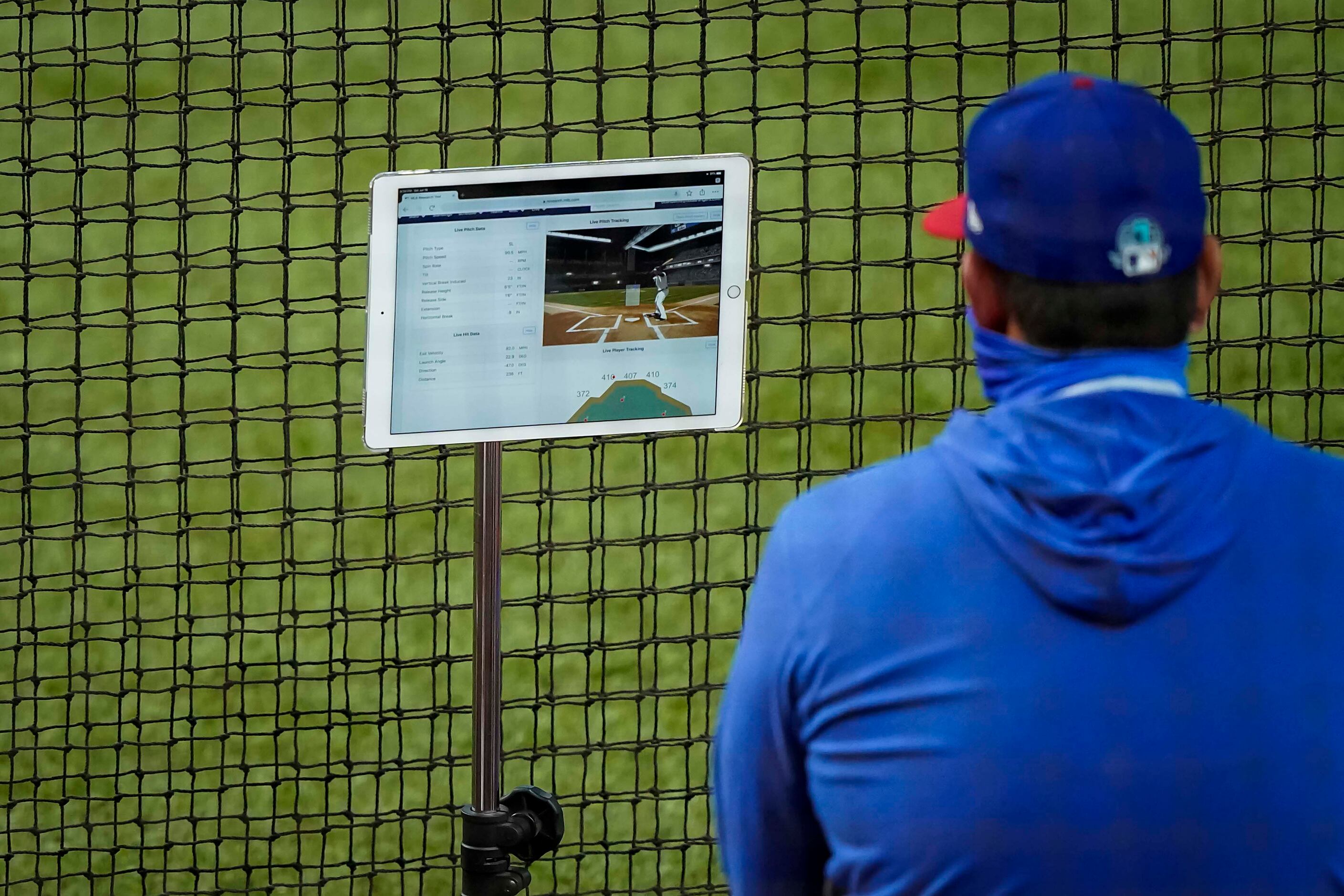 Pitching coach Julio Rangel looks over tracking data on a tablet in an intrasquad game...