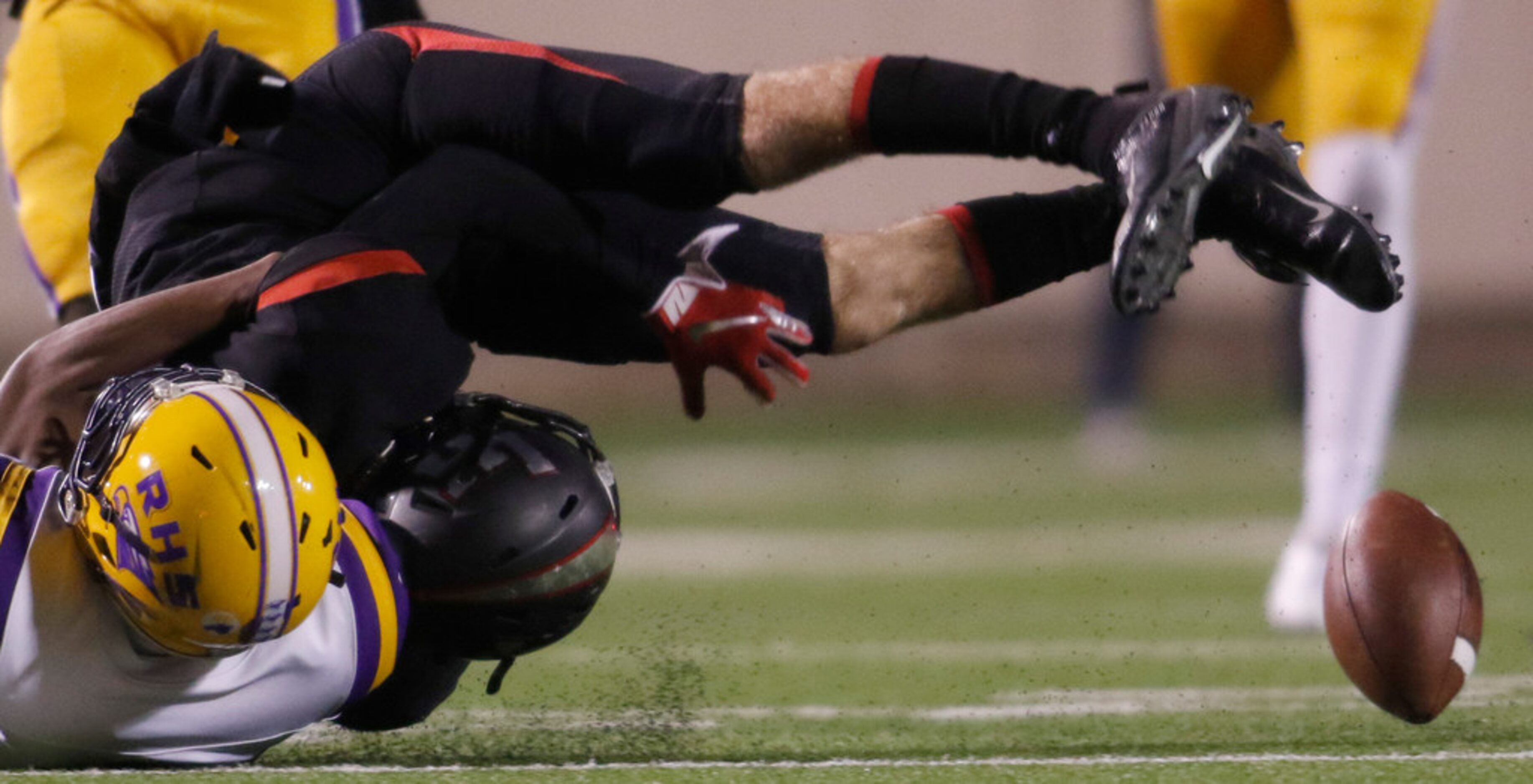 Lake Highlands receiver Evan Moudy (5) loses the ball as he is upended following a jarring...