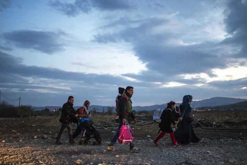
Migrants and refugees cross the Greece-Macedonia border this week. Dallas resident Shkelqim...