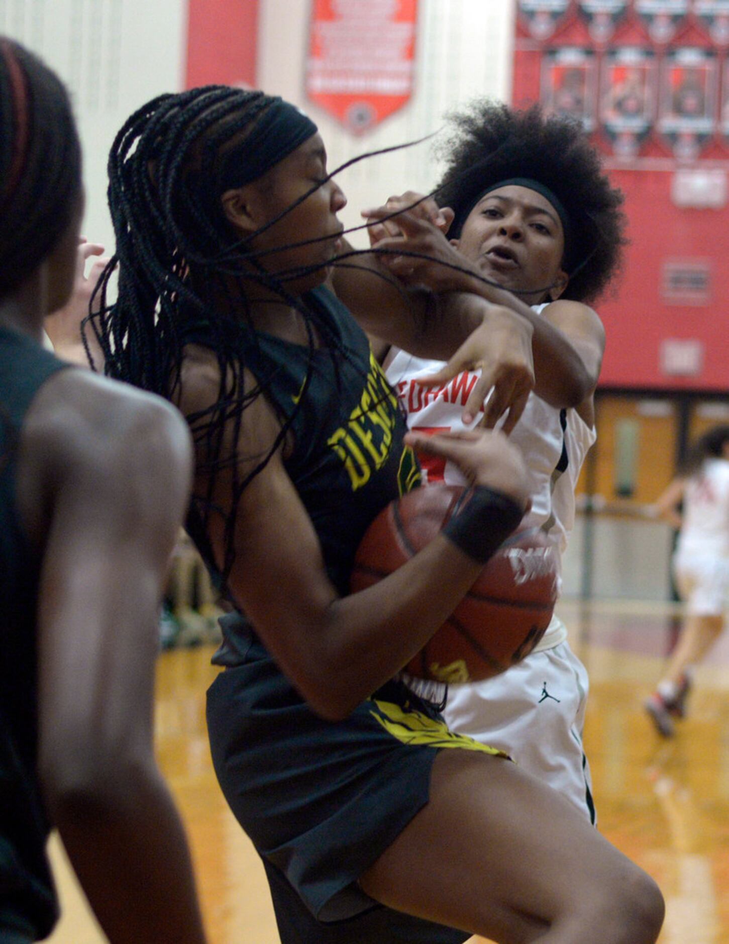 DeSoto's Sa'Myah Smith, left, and Liberty's Zoe Junior go after a rebound in the second half...