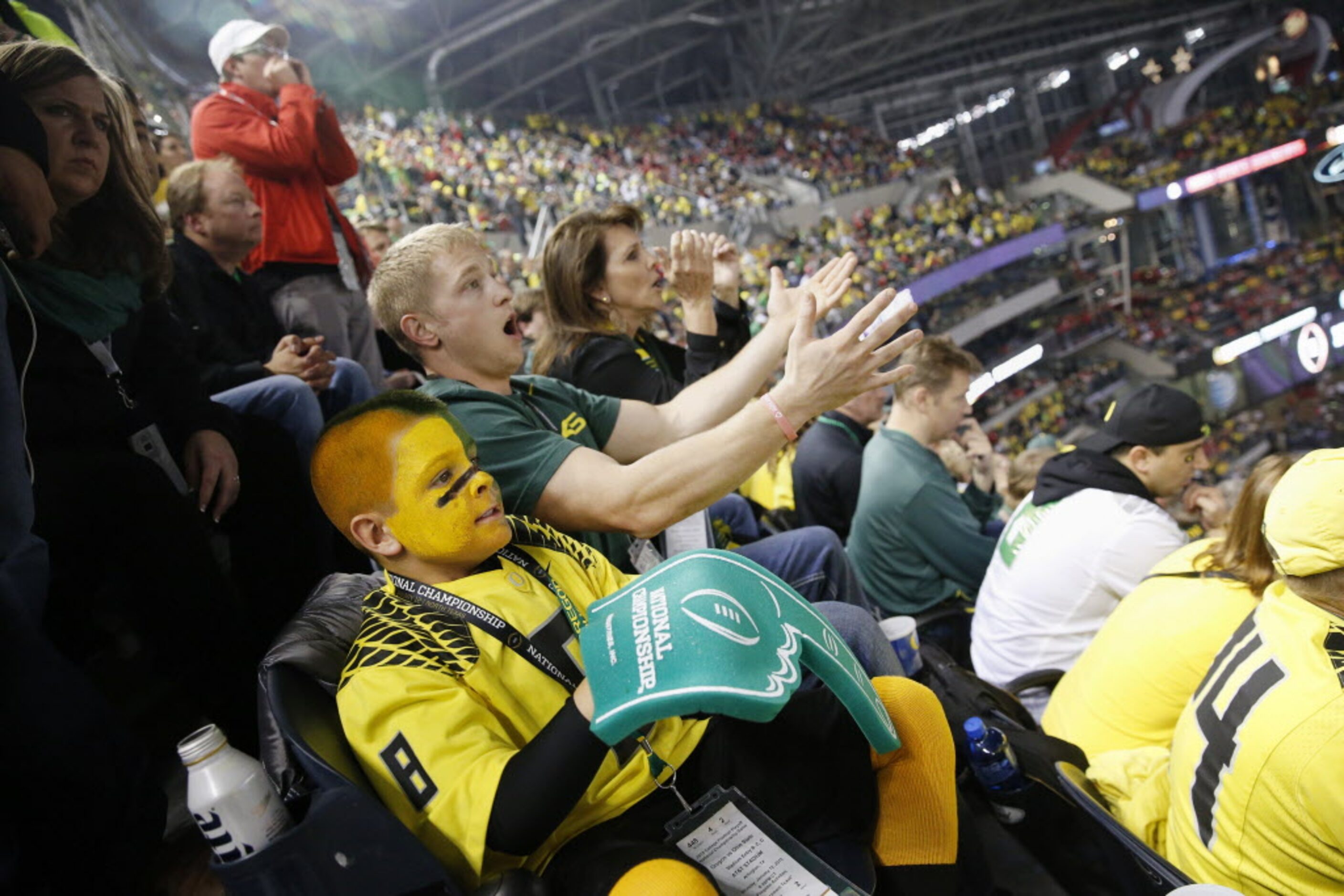 Oregon Ducks fan Zack Homan, 8, of Sebastopol, California, reacts to a play with his uncle,...