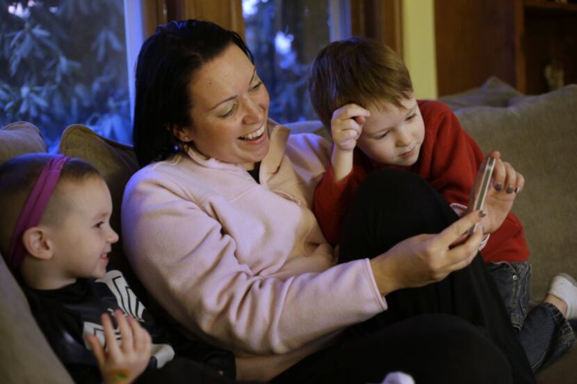 Julie Young, a Boston behavioral analyst, shows sons Nolan, 3, (left) and Jameson, 4,...