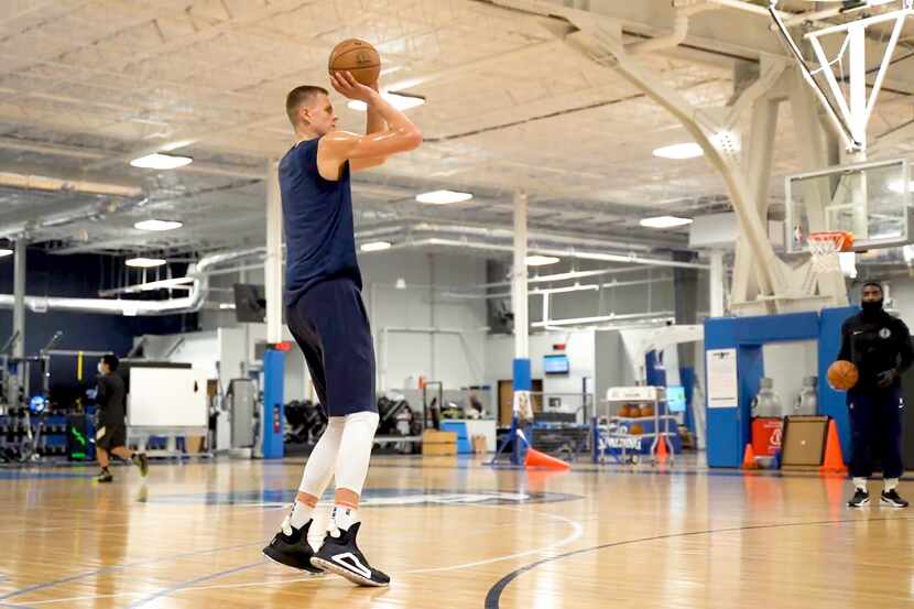 Dallas Mavericks power forward Kristaps Porzingis shoots baskets during the first mandatory...