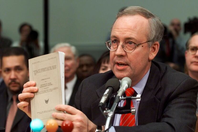 FILE - Independent Counsel Kenneth Starr holds a copy of his report while testifying on...