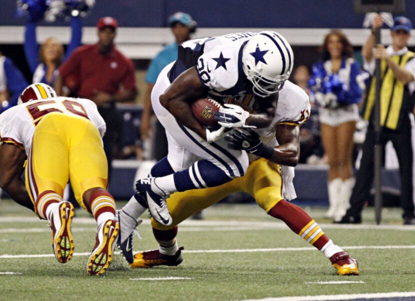 Dallas Cowboys running back Felix Jones (28) jumps past Washington Redskins free safety...