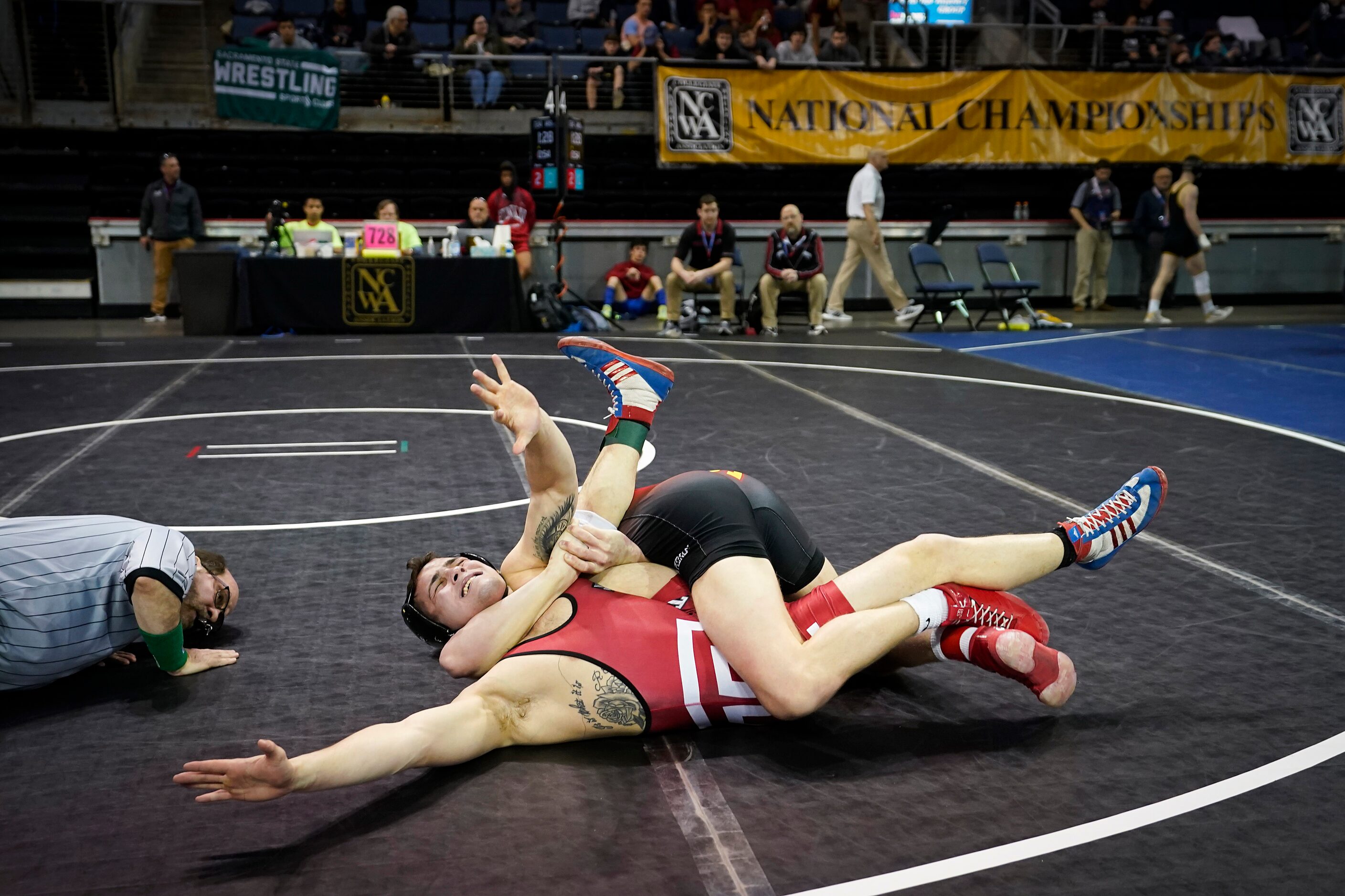 Cary Palmer of Temple (facing) is pinned by Carter Weeks of Iowa State in a 149 lbs...