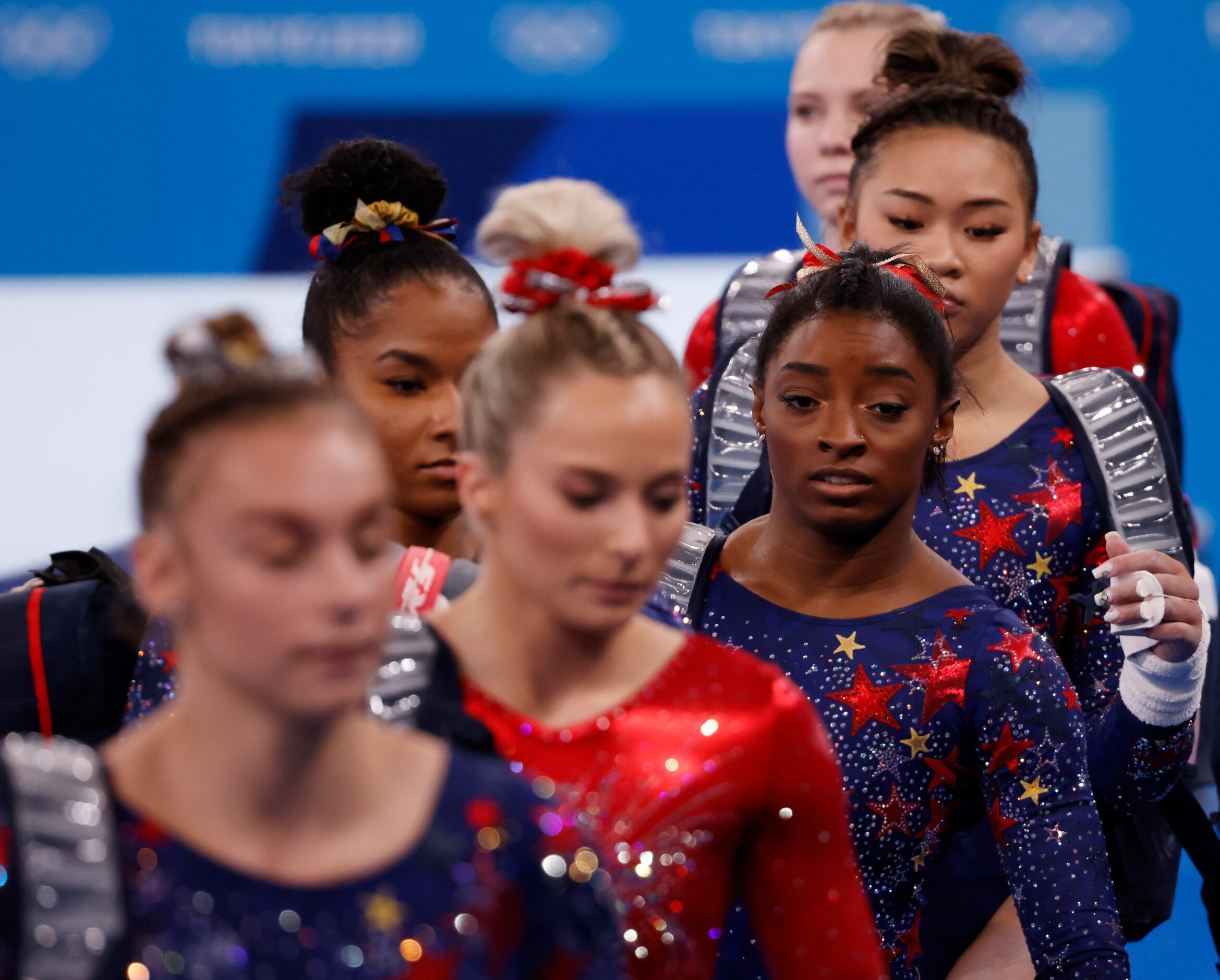 USA’s Simone Biles and teammates make their way to the uneven bars during a women’s...