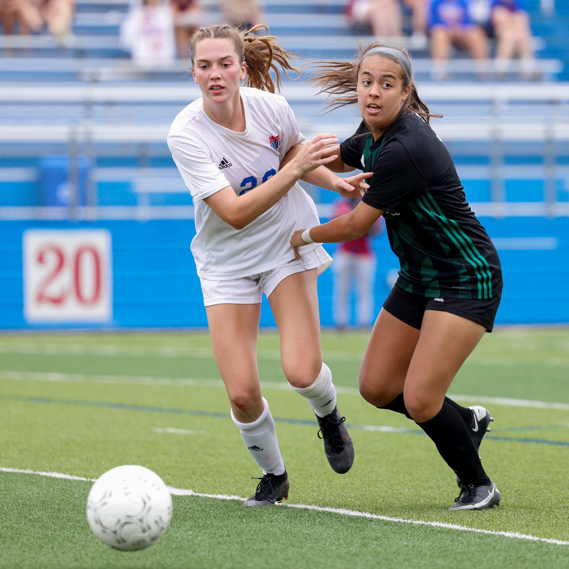 Austin Westlake defender Izzy Scott (20) and Southlake’s Bella Clahane (7) battle for a...