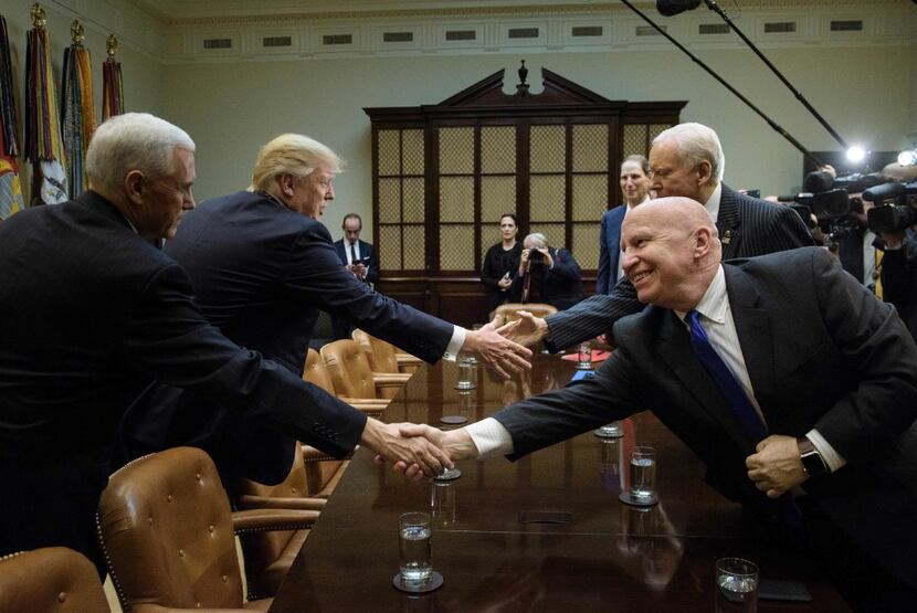 Texas Rep. Kevin Brady (front right) and President Donald Trump are both pursuing tax...