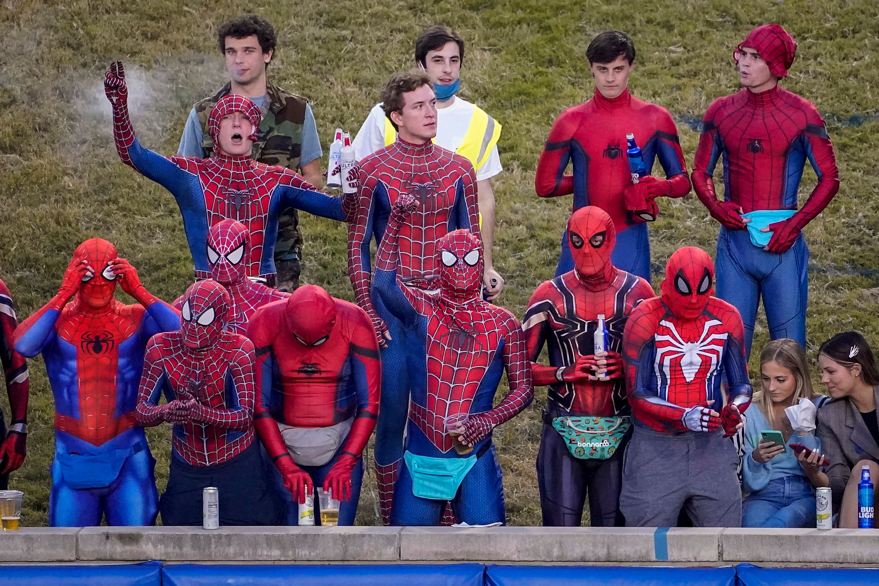 Costumed SMU fans cheer as their team takes the field for a Halloween night NCAA football...