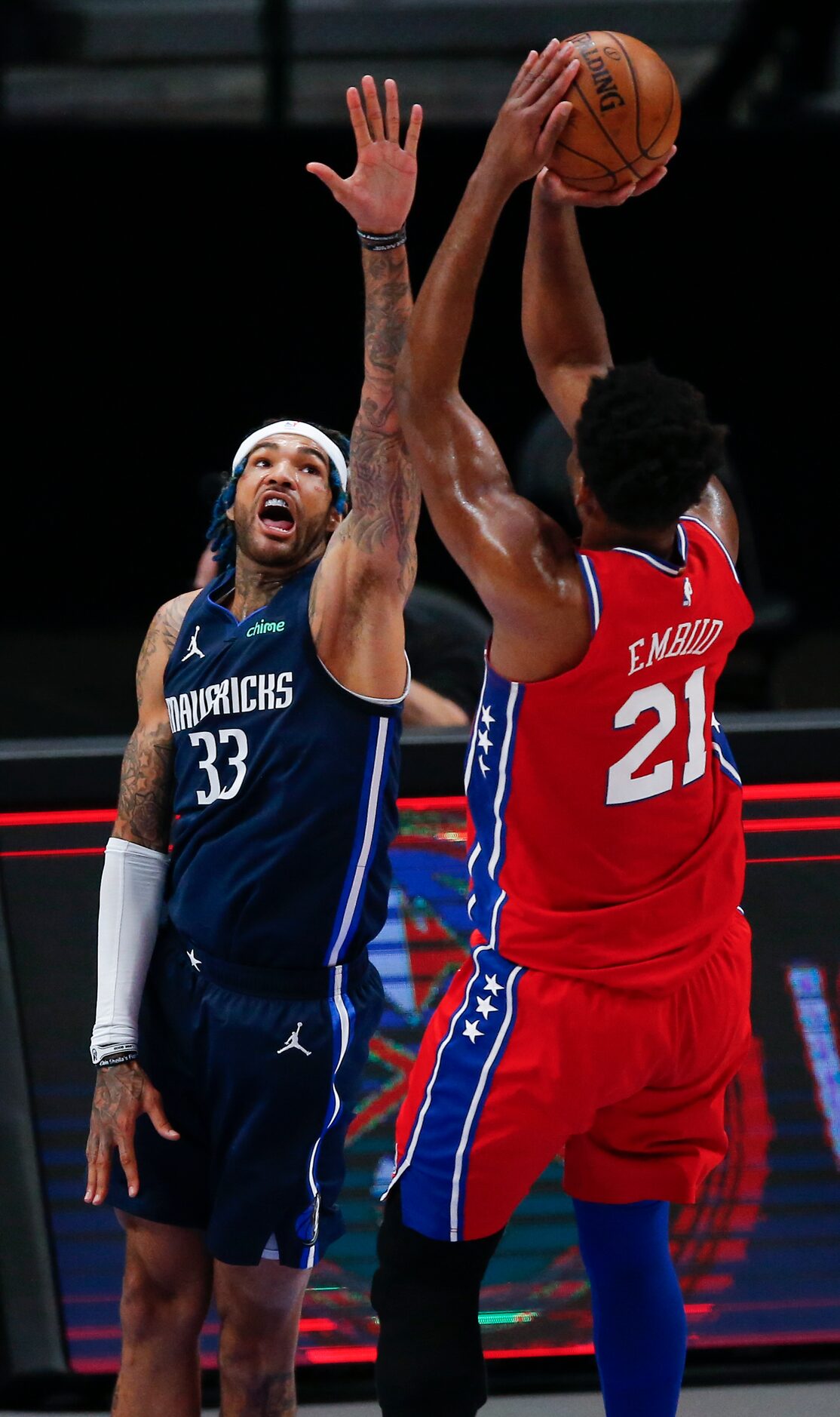 Philadelphia 76ers forward Joel Embiid (21) attempts a shot as Dallas Mavericks forward...