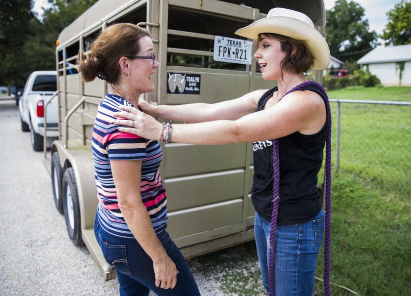 Elizabeth Hendel (left) of Royce City, Texas and Jess Anselment share a moment after loading...