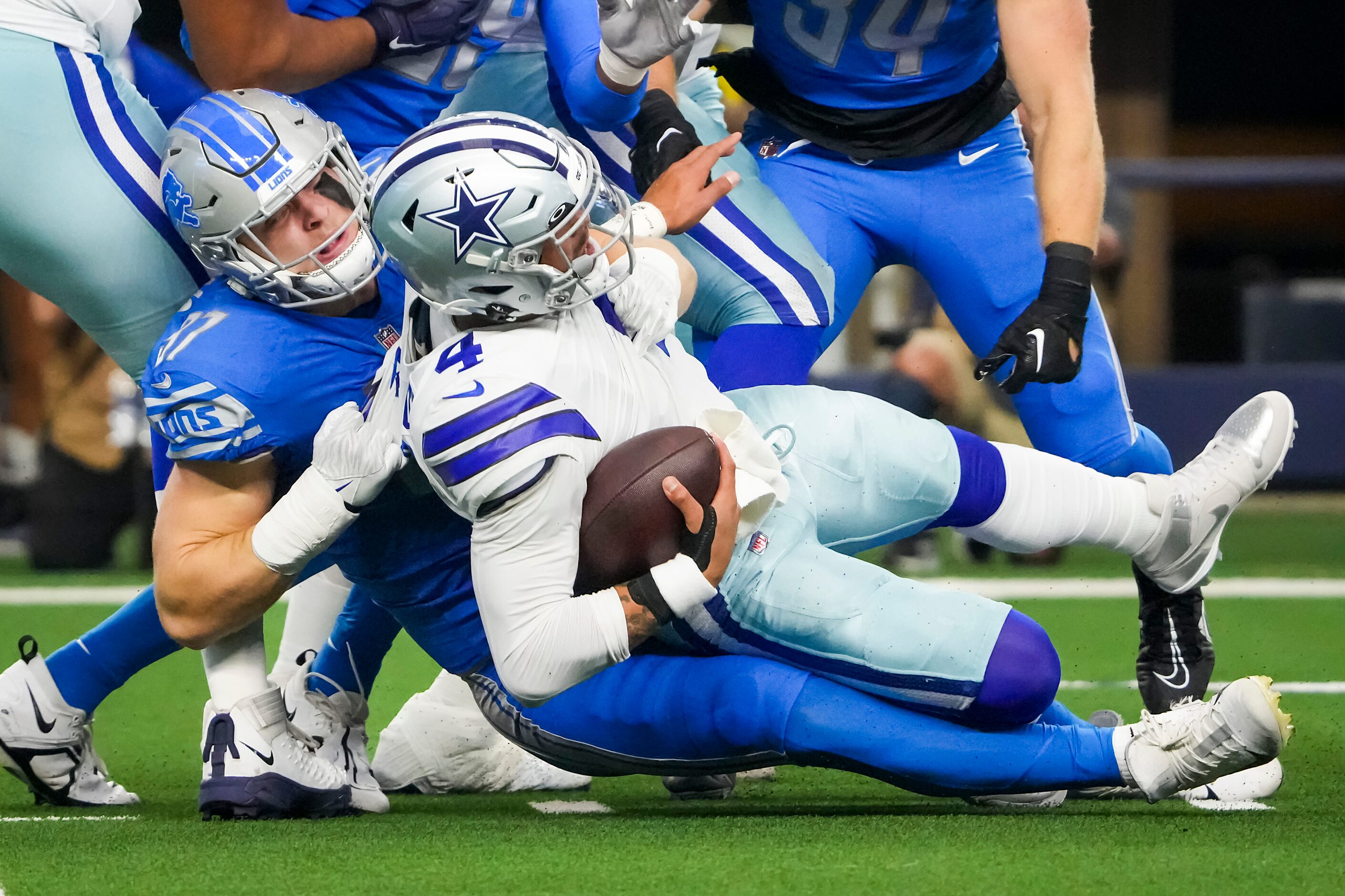 Dallas Cowboys quarterback Dak Prescott (4) is sacked by Detroit Lions defensive end Aidan...