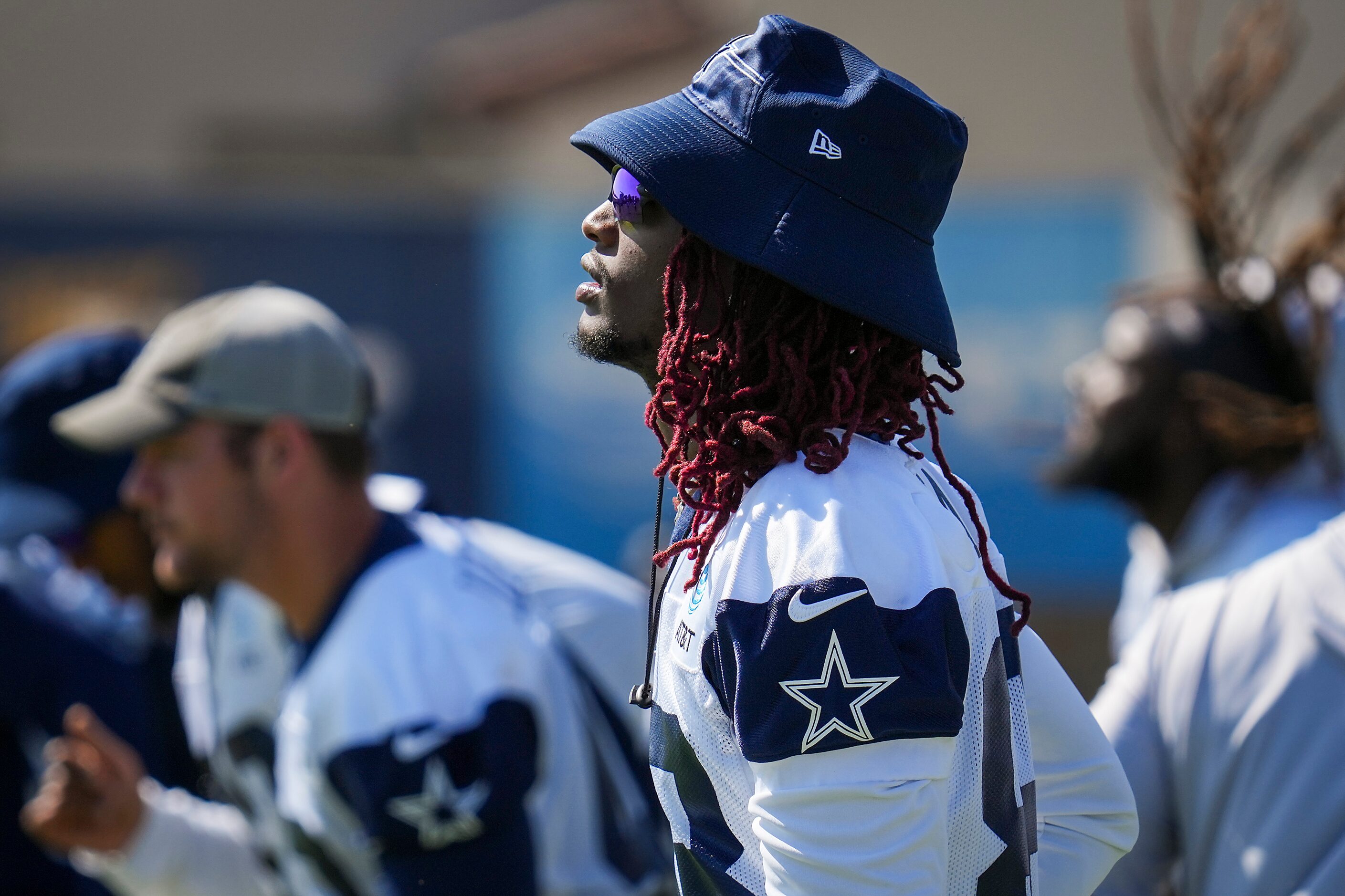 Dallas Cowboys wide receiver CeeDee Lamb  stretches with teammates during a training camp...