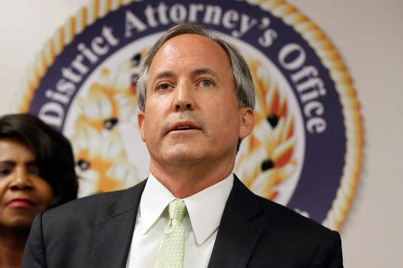 Texas Attorney General Ken Paxton speaks at a news conference in Dallas. 