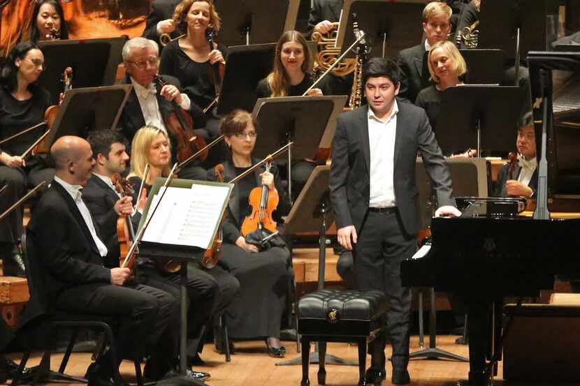 Pianist Behzod Abduraimov acknowledges the crowd before he and the Dallas Symphony perform...