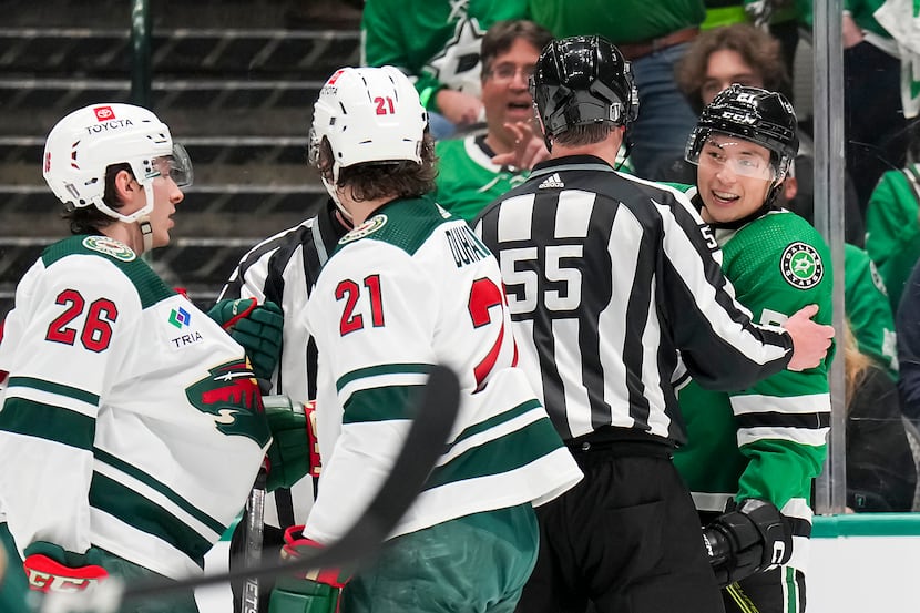 Officials separate Dallas Stars left wing Jason Robertson (right) from Minnesota Wild center...