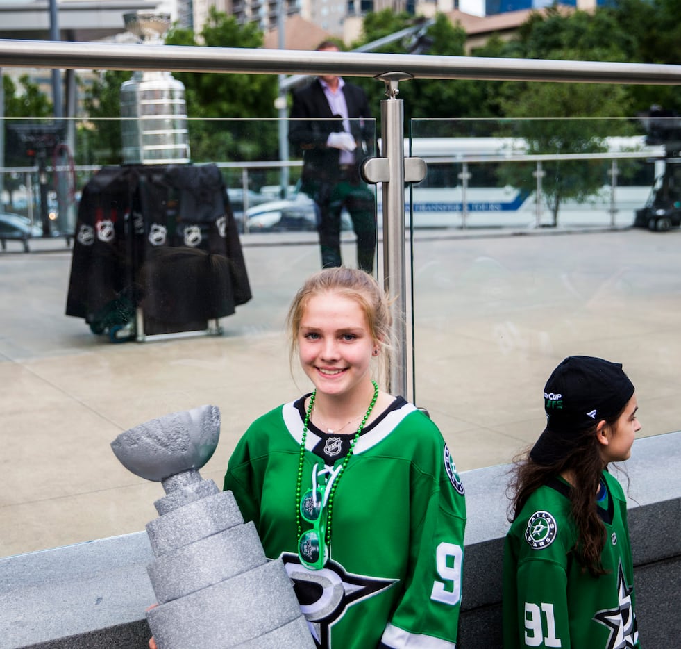 Megan Filippo holds a model that she made of the Stanley Cup while posing for a photo with...