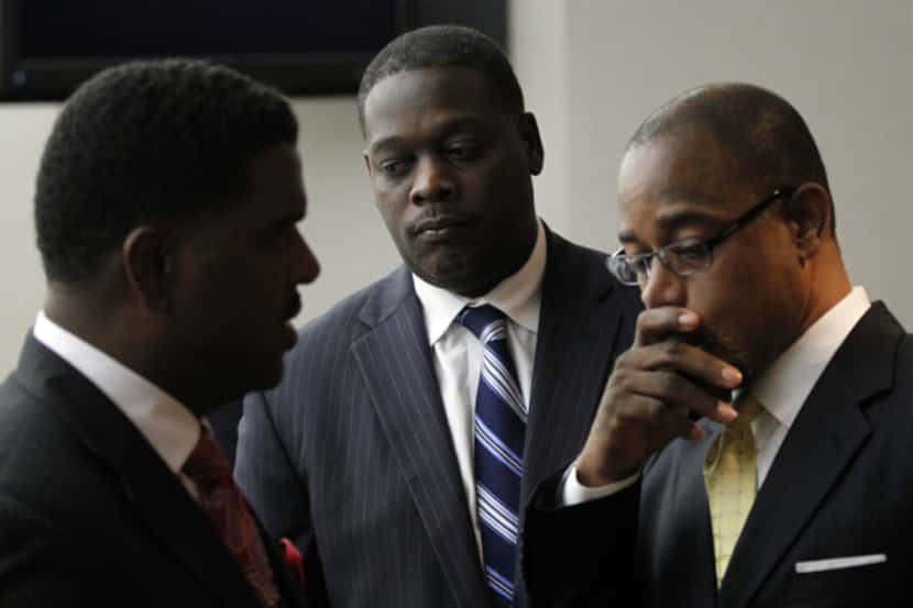 Dallas County District Attorney Craig Watkins (center) and attorneys Heath Harris (left) and...