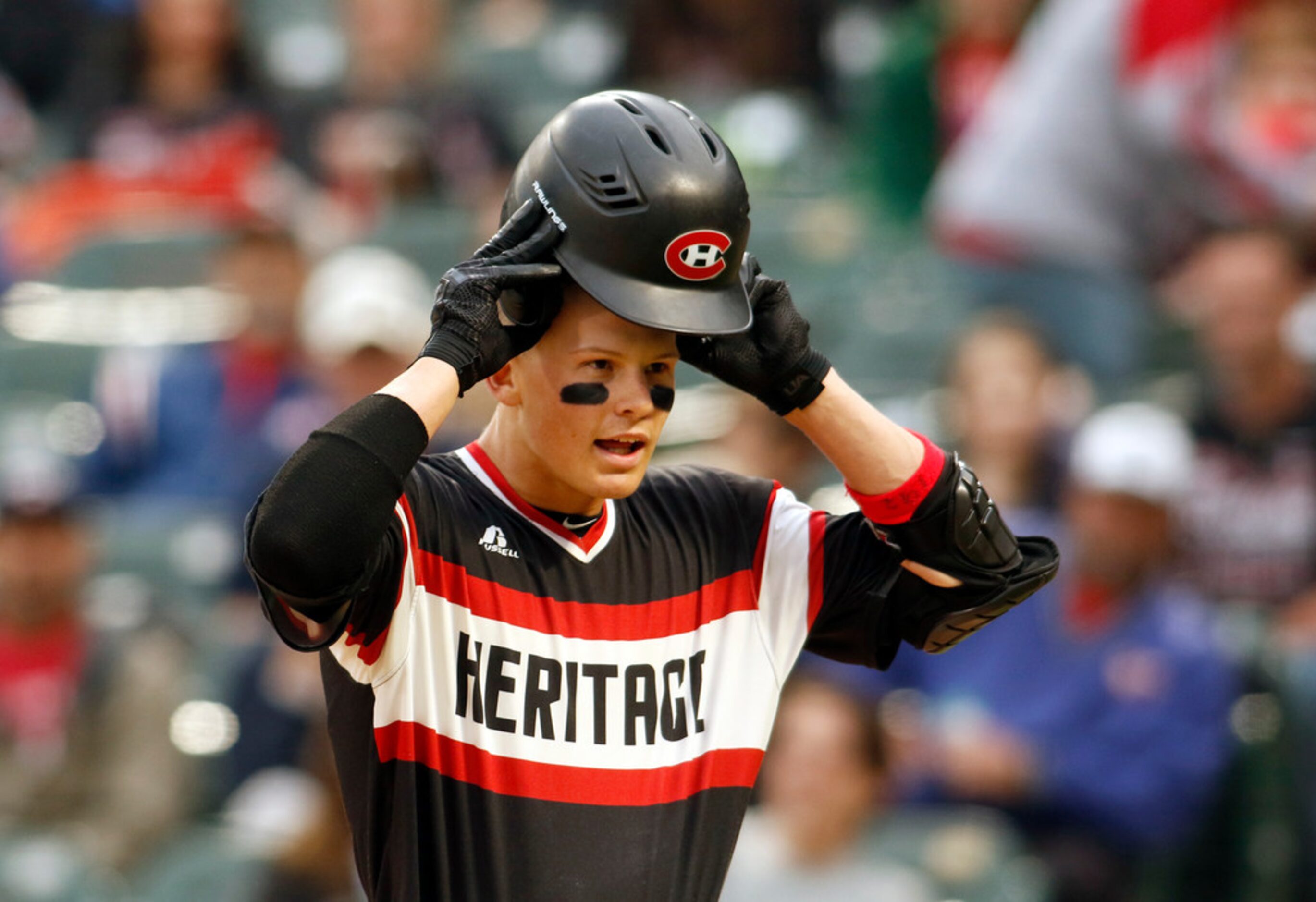 Bobby Witt Jr. (17) replaces his helmet following his solo home run blast to break a...